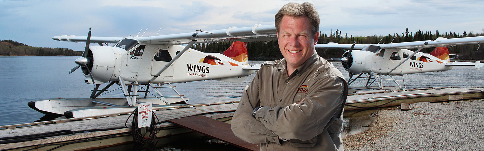 Curt Enns, Owner/Operator in front of docked Piston Beaver aircraft